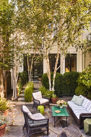 Janus et Cie furniture creates an inviting seating area in the garden.