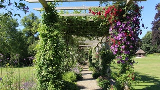 Image may contain Architecture Building House Housing Porch Garden Nature Outdoors Arbour Patio Pergola and Grass