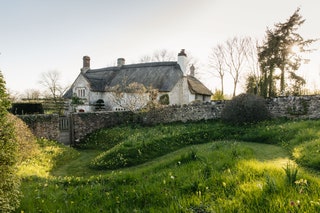 Image may contain Cottage Housing House Building Grass Plant Nature Outdoors Grassland Field and Countryside